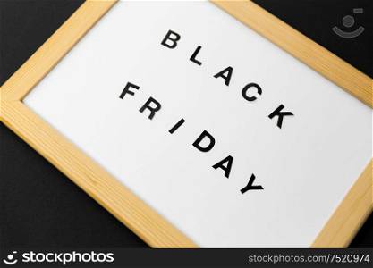shopping, sale and outlet concept - white magnetic board with black friday words. magnetic board with black friday words