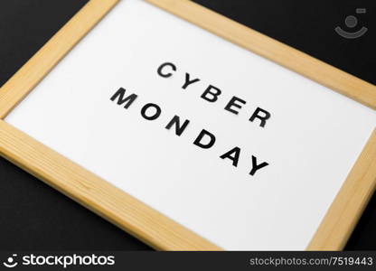 shopping, sale and outlet concept - white magnetic board with cyber monday words on black background. magnetic board with cyber monday words
