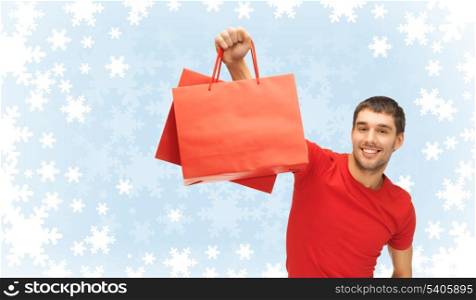 shopping, sale and winter concept - handsome smiling man with shopping bags