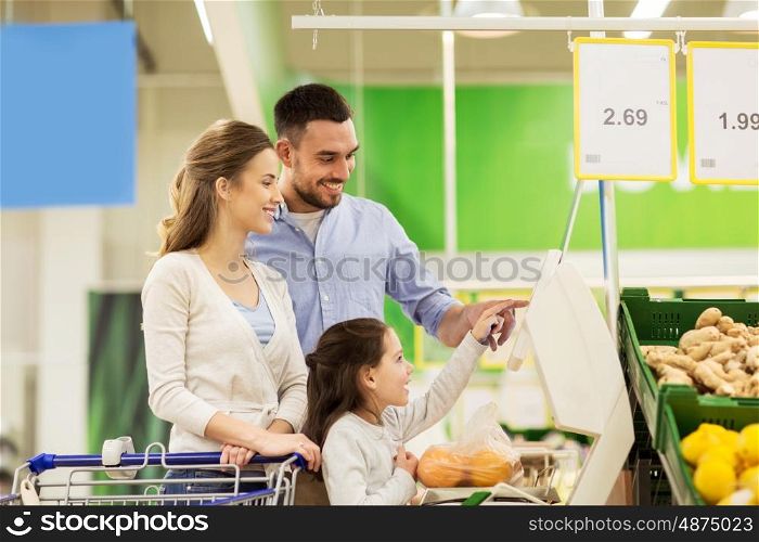 shopping, sale, consumerism and people concept - happy family with child weighing oranges on scale at grocery store