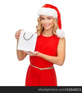 shopping, sale, gifts, christmas, x-mas concept - smiling woman in red dress and santa helper hat with shopping bag