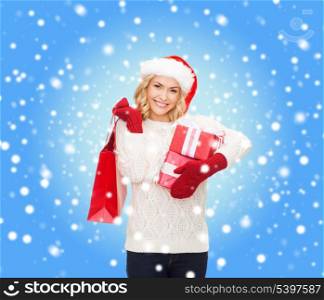 shopping, sale, gifts, christmas, x-mas concept - smiling woman in santa helper hat with shopping bags and gift boxes