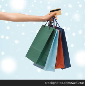 shopping, sale, gifts, christmas, x-mas concept - woman with shopping bags and credit card