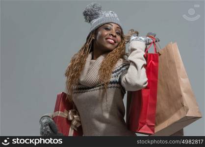 Shopping, sale, gifts, christmas, xmas concept - smiling woman in knitted dress with shopping bags