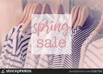Shopping Spring Sale Text on clothes for women hanging on hangers