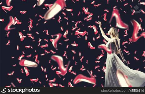 Shopping therapy. Young woman in white dress and many falling shoes