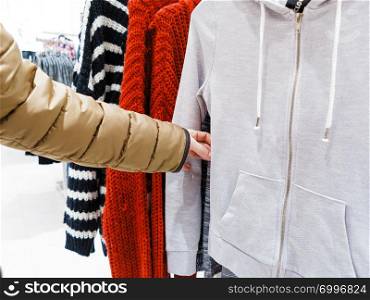 Shopping time concept. Part body buyer customer client wathing touching clothes in botique shop market.. Buyer watching clothes in shop.