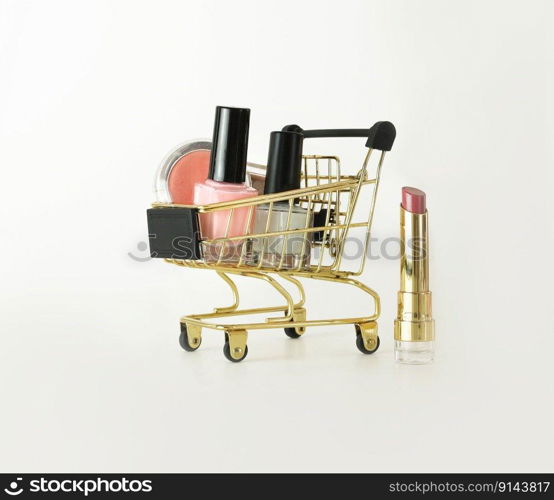 Shopping trolley full of make up and cosmetic goods on white background. Black friday concept. Sale and discount concept. Goods for women. Closeup of a basket with products for make-up.. Shopping trolley full of make up and cosmetic goods on white background. Black friday concept. Sale and discount. Goods for women. Closeup of a basket with products for make-up.