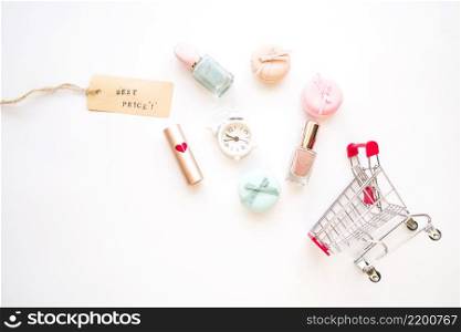 shopping trolley with little alarm clock macaroons sale tag lipstick nail polish