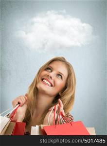 Shopping woman holding bags on studio background with thoughts cloud overhead