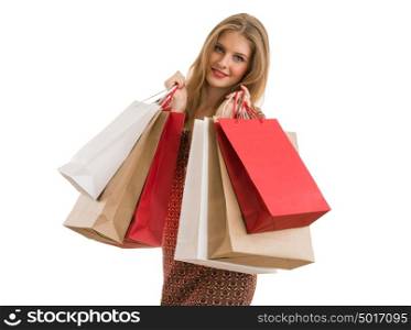 Shopping woman holding shopping bags looking at camera on white background at copy space.