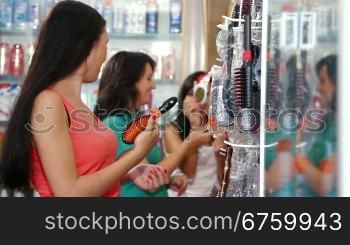 Shopping women choosing cosmetics in the beauty shop