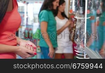 Shopping women choosing cosmetics in the beauty shop