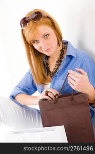 Shopping young woman with bag look at camera