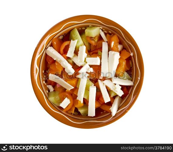 Shopska salad - also known as Bulgarian , Macedonian,Serbian; Bosnian and Croatian salad.made from tomatoes, cucumbers, onion/scallions, raw or roasted peppers, sirene,isolated