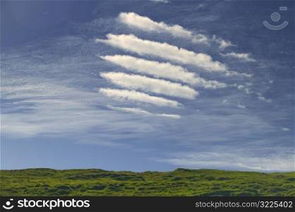 Short Cloud Lines In A Blue Sky Over The Green Countryside