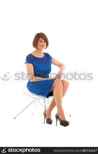Short haired woman sitting on transparent chair while looking at camera on white background. Isolated . Short haired woman sitting on transparent chair