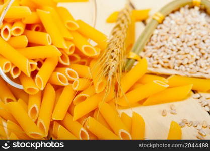 short Italian pasta penne with durum wheat grains