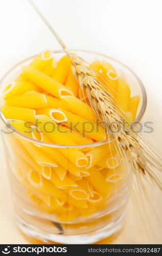 short Italian pasta penne with durum wheat grains