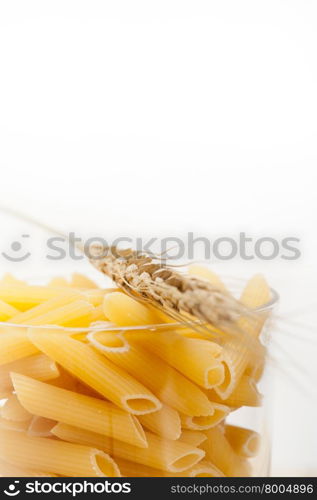 short Italian pasta penne with durum wheat grains