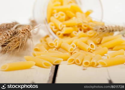 short Italian pasta penne with durum wheat grains