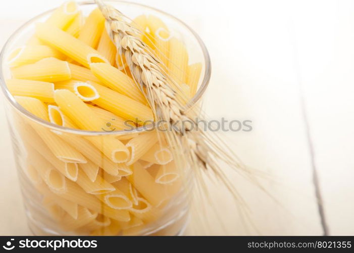 short Italian pasta penne with durum wheat grains