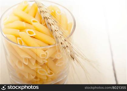 short Italian pasta penne with durum wheat grains