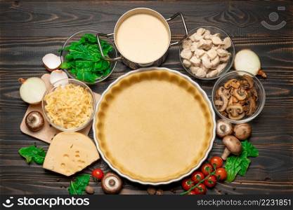shortbread dough for baking quiche tart in ceramic baking form and ingredients. shortbread dough for baking quiche tart in baking form and ingredients