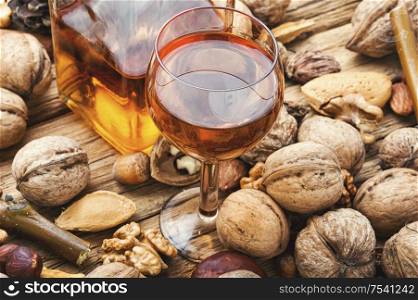 Shot glass with aromatic alcohol from nuts.Nut liquor.Tincture on nuts.. Autumn nutty liquor
