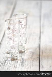 Shot glasses with crushed ice on the wooden table