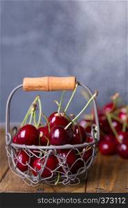 shot in vintage style - red cherry in a small basket