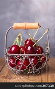 shot in vintage style - red cherry in a small basket