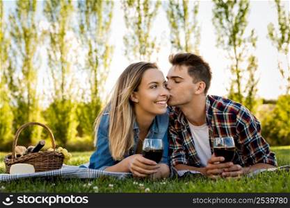 Shot of a beautiful couple in love making a picnic on the park