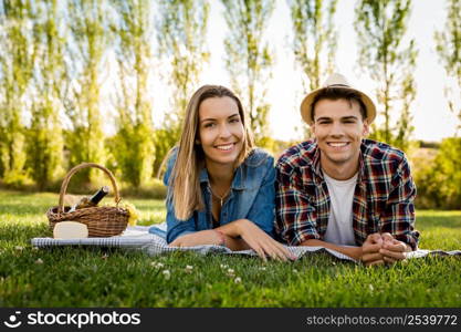 Shot of a beautiful couple on the park having fun together while making a picnic