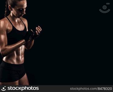 Shot of a beautiful fit young woman getting ready for a kickbox workout