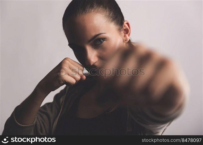 Shot of a beautiful young woman practicing kickboxing