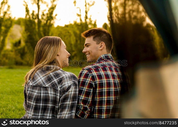 Shot of a happy couple c&ing on the nature