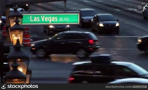Shot of a Las Vegas Blvd street sign, with traffic moving in the background at dusk, with audio