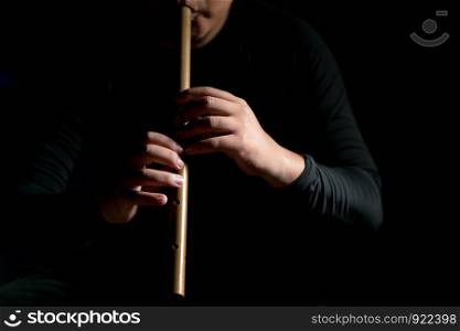 Shot of a man blowing thai style flute, Thai culture, musicology background, music skills learning and education.