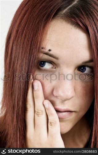 Shot of a pensive girl holding her head with hand.