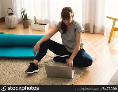 Shot of a woman at home, ready for follow your online class of yoga