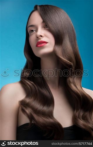Shot of a woman with long glossy curly hairstyle