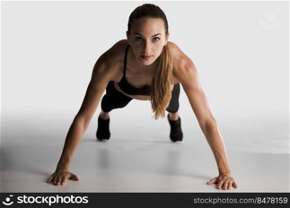 Shot of a yopung woman doing push-ups 