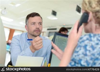 shot of a young businessman talking with female colleague