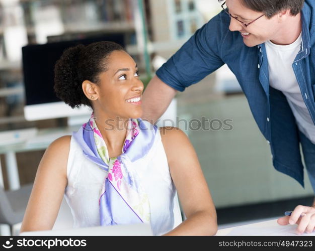 Shot of a young office worker getting some assistance from her manager