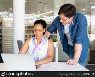 Shot of a young office worker getting some assistance from her manager