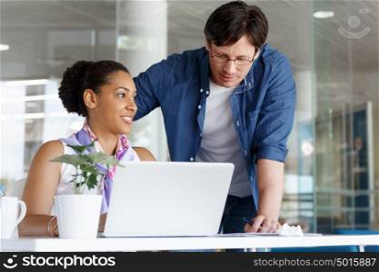 Shot of a young office worker getting some assistance from her manager