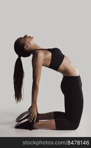 Shot of a young woman doing stretching exercises 