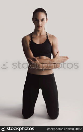 Shot of a young woman doing stretching exercises 