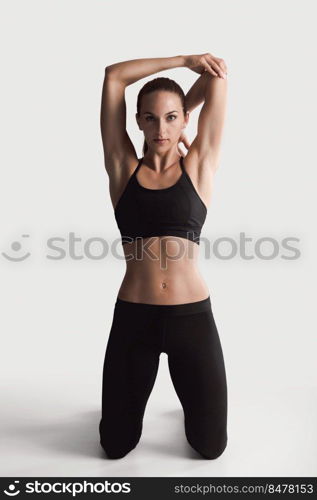 Shot of a young woman doing stretching exercises 
